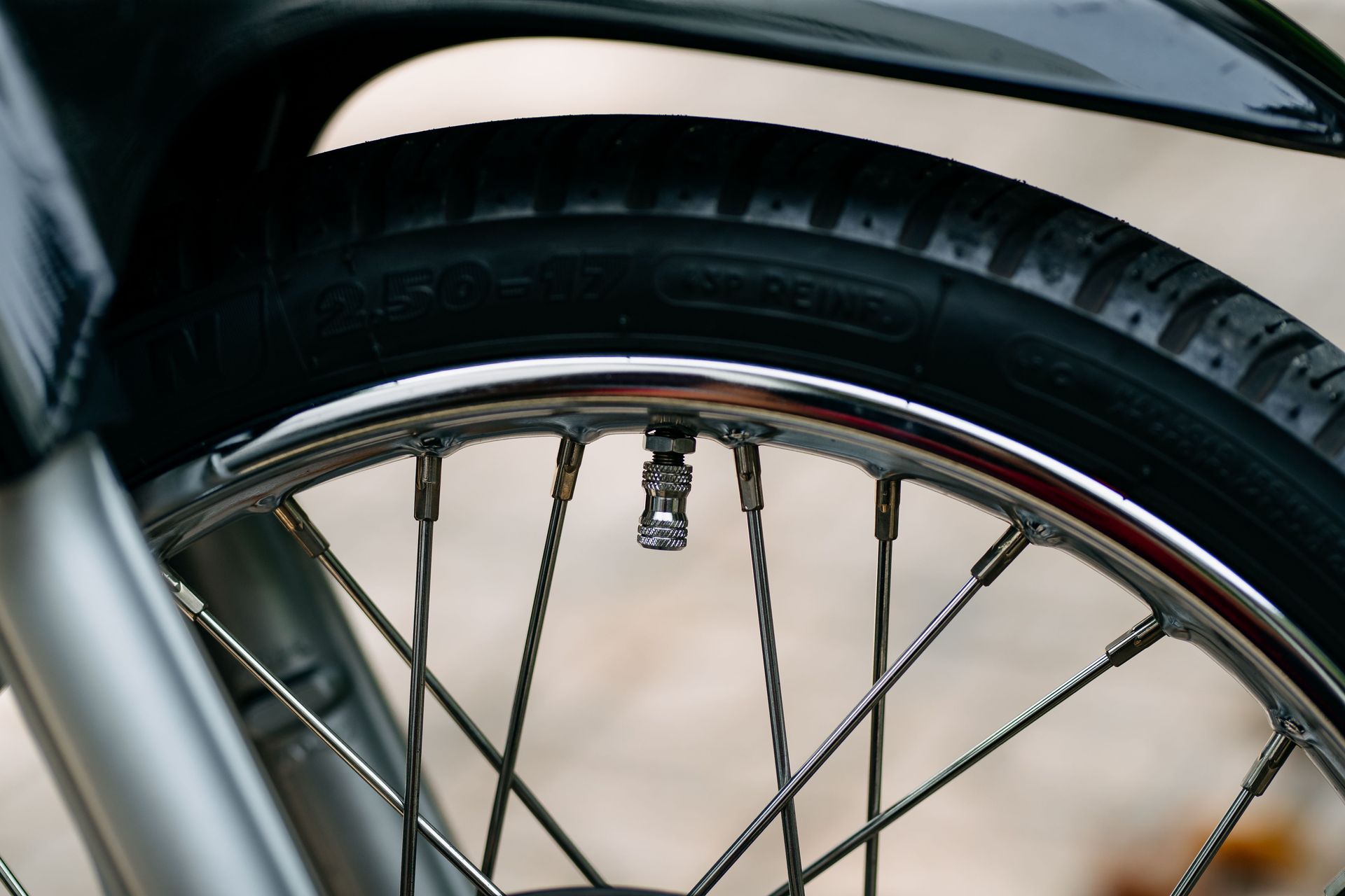 Detailed image of a bicycle wheel showcasing the tire treads and spokes in a close-up shot.